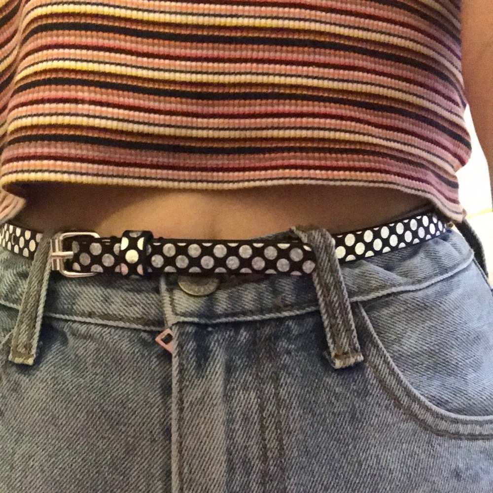 A black and silver iridescent polka dot belt.